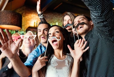 Adults posing with mustaches