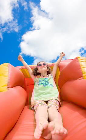 Child on inflatable slide