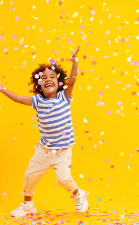 Child running in confetti